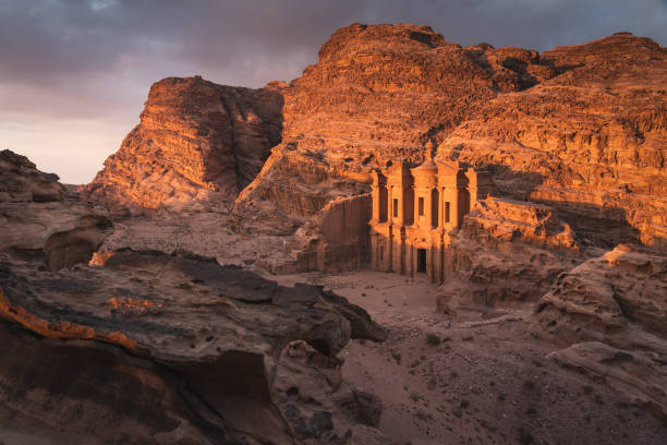 the monastery or ad deir at beautiful sunset in petra ruin and ancient city, jordan, arab - petra foto e immagini stock